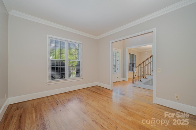 108 Bare Foot Ln, Mooresville, NC 28117 - empty room with light wood-style flooring, baseboards, stairs, and crown molding