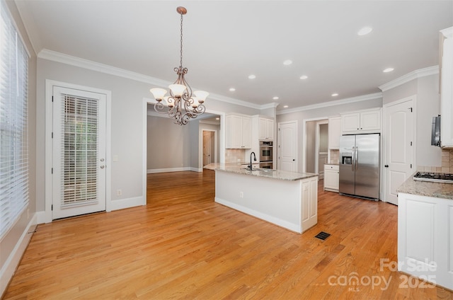 108 Bare Foot Ln, Mooresville, NC 28117 - kitchen with backsplash, a sink, a chandelier, appliances with stainless steel finishes, and white cabinetry