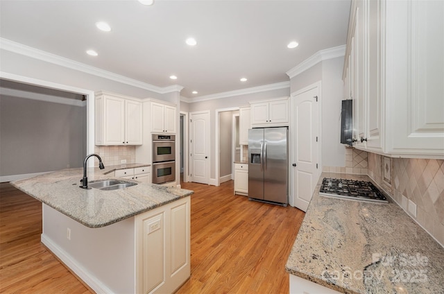 108 Bare Foot Ln, Mooresville, NC 28117 - kitchen featuring light wood finished floors, a sink, a peninsula, tasteful backsplash, and appliances with stainless steel finishes