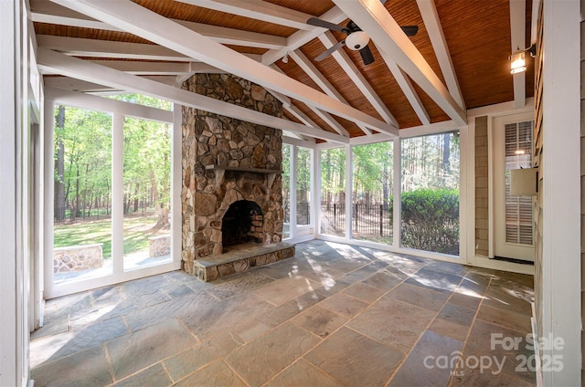 108 Bare Foot Ln, Mooresville, NC 28117 - unfurnished living room with vaulted ceiling, stone tile flooring, and a wealth of natural light