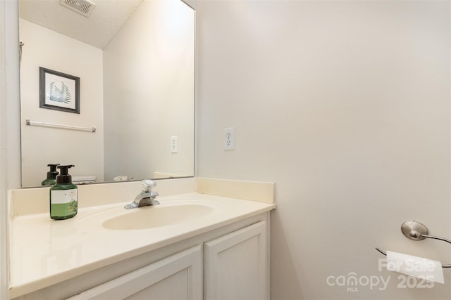 bathroom with visible vents and vanity