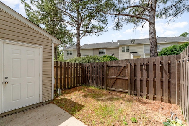 view of yard featuring a gate and a fenced backyard