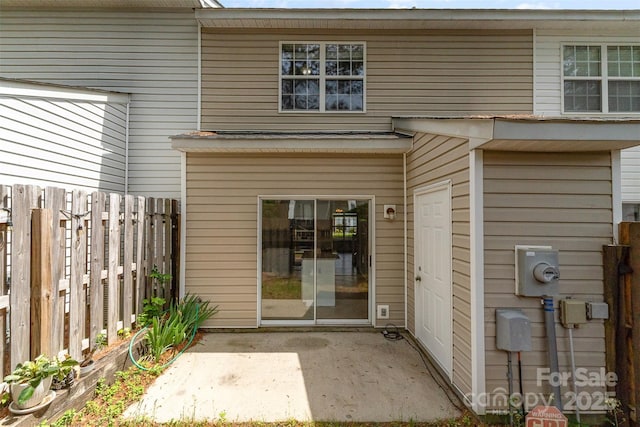 doorway to property featuring a patio and fence