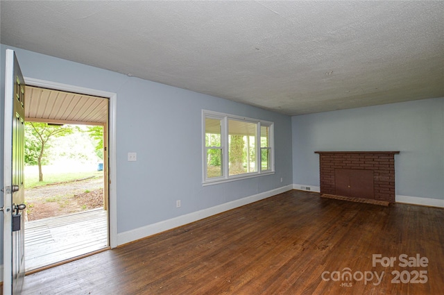 unfurnished living room with a healthy amount of sunlight, wood-type flooring, and baseboards