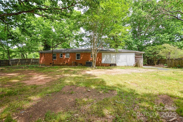 exterior space featuring a fenced backyard, entry steps, and central air condition unit
