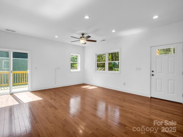 1938 Upper Ridgewood Blvd, Hendersonville, NC 28791 - unfurnished living room with hardwood / wood-style floors, visible vents, a ceiling fan, and baseboards