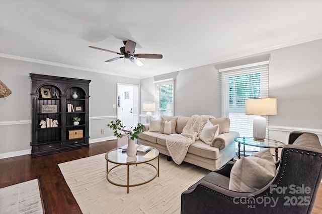 living room featuring wood finished floors, ceiling fan, ornamental molding, and baseboards