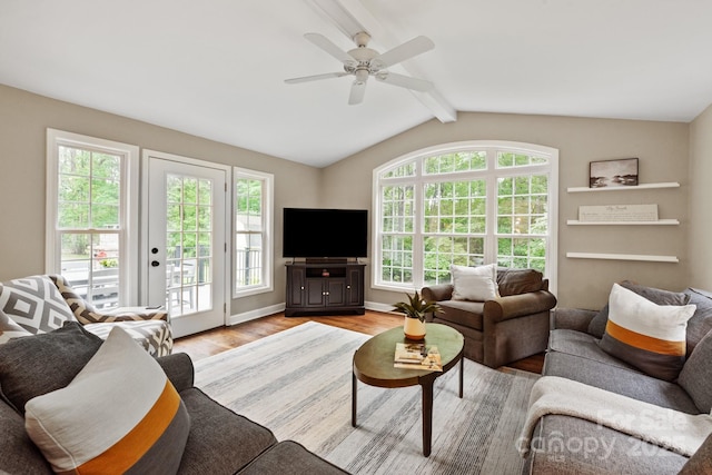 living room with lofted ceiling with beams, a ceiling fan, and light wood-style floors