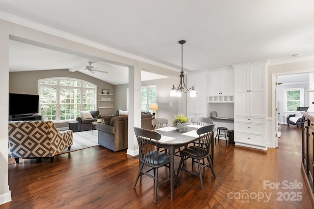 dining area with a ceiling fan, a healthy amount of sunlight, dark wood-type flooring, and vaulted ceiling
