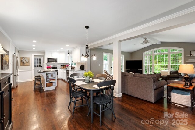 dining room featuring lofted ceiling, crown molding, dark wood-style flooring, recessed lighting, and a ceiling fan