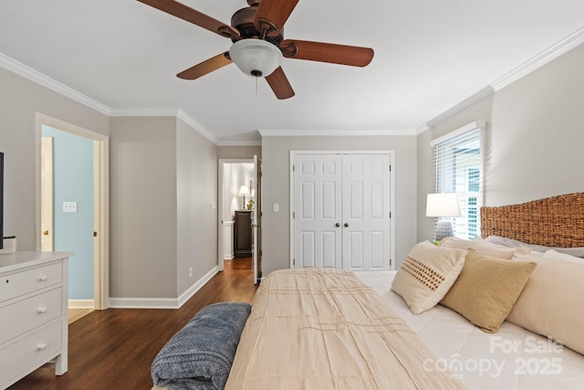 bedroom with a closet, crown molding, a ceiling fan, baseboards, and wood finished floors