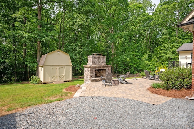 view of patio / terrace with an outdoor stone fireplace, a storage unit, and an outdoor structure