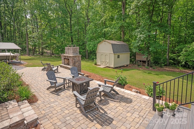 view of patio / terrace with a fire pit, an outdoor structure, and a shed