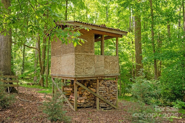 view of outbuilding featuring a view of trees