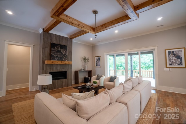 724 Ideal Way, Charlotte, NC 28203 - living area with beam ceiling, recessed lighting, a large fireplace, wood finished floors, and ornamental molding