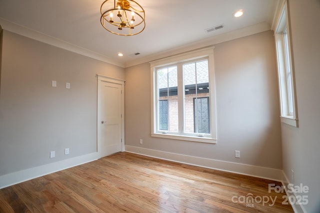 724 Ideal Way, Charlotte, NC 28203 - spare room with a chandelier, light wood finished floors, crown molding, and recessed lighting