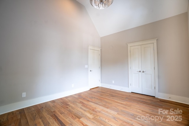724 Ideal Way, Charlotte, NC 28203 - unfurnished bedroom featuring light wood-style floors and high vaulted ceiling