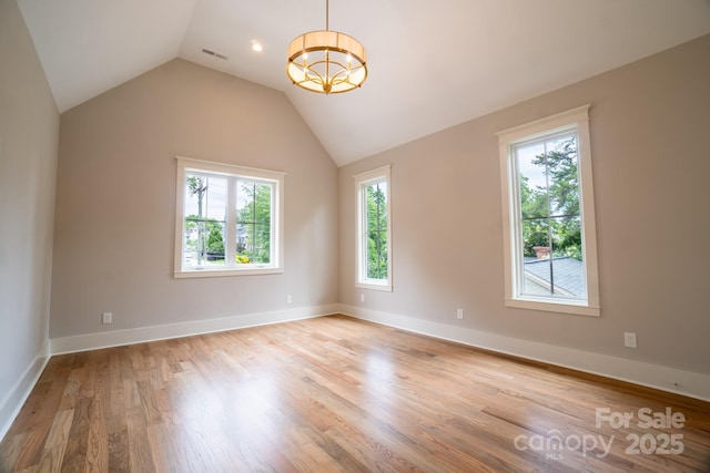 724 Ideal Way, Charlotte, NC 28203 - unfurnished room featuring light wood-style flooring, lofted ceiling, and a chandelier
