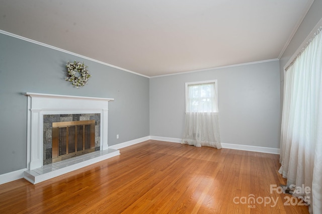 3340 Wrenwood Dr, Newton, NC 28658 - unfurnished living room with baseboards, crown molding, a tile fireplace, and light wood-type flooring