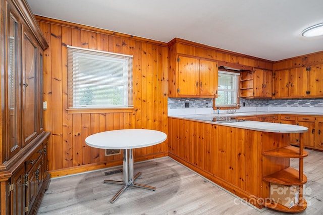 3340 Wrenwood Dr, Newton, NC 28658 - kitchen with light wood-style flooring, decorative backsplash, open shelves, brown cabinetry, and light countertops