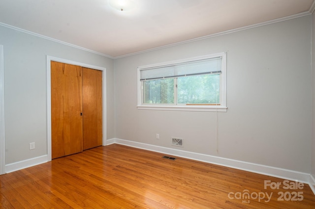 3340 Wrenwood Dr, Newton, NC 28658 - unfurnished bedroom featuring baseboards, ornamental molding, light wood-style floors, and visible vents