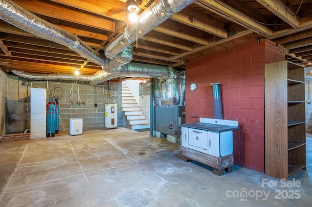3340 Wrenwood Dr, Newton, NC 28658 - unfinished below grade area with stairs, heating unit, electric water heater, and concrete block wall