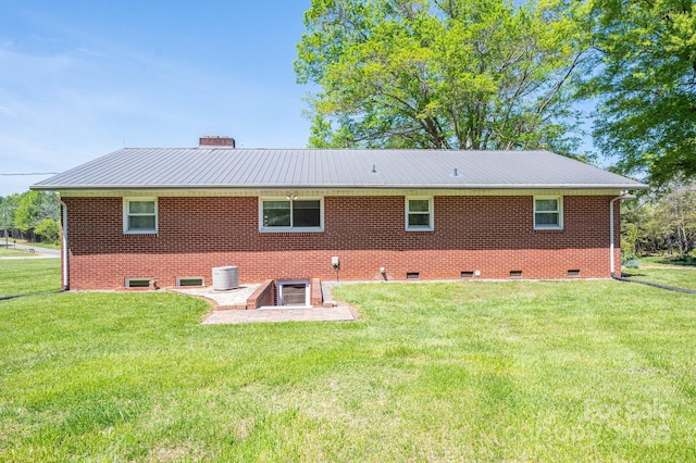 3340 Wrenwood Dr, Newton, NC 28658 - rear view of house featuring a chimney, a yard, and metal roof