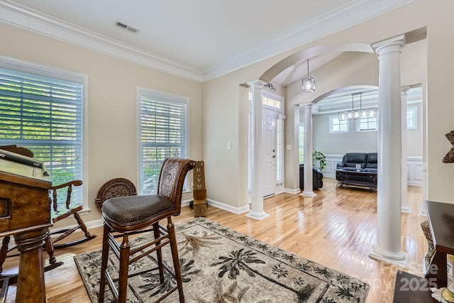 1151 Donelea Ln NW, Concord, NC 28027 - foyer entrance with arched walkways, visible vents, light wood-style floors, ornate columns, and crown molding