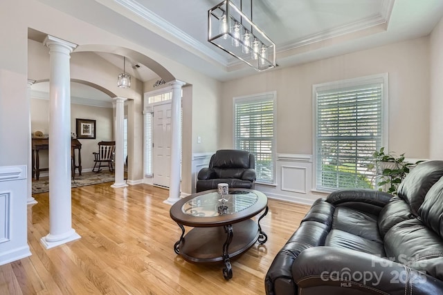 1151 Donelea Ln NW, Concord, NC 28027 - living room with light wood-style flooring, arched walkways, a raised ceiling, ornamental molding, and ornate columns