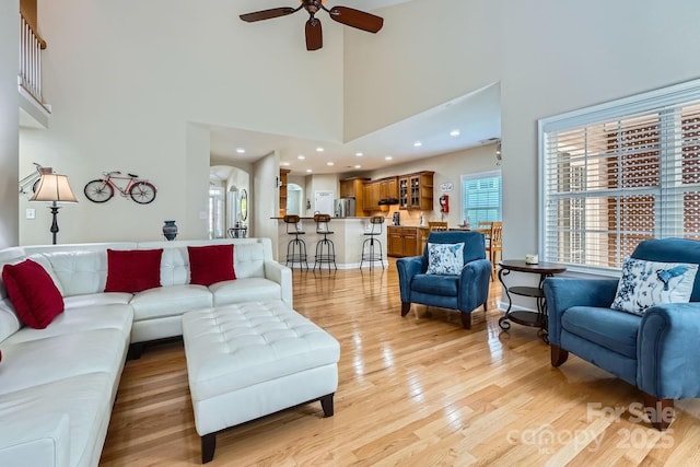 1151 Donelea Ln NW, Concord, NC 28027 - living room with light wood-style floors, a healthy amount of sunlight, a towering ceiling, and ceiling fan
