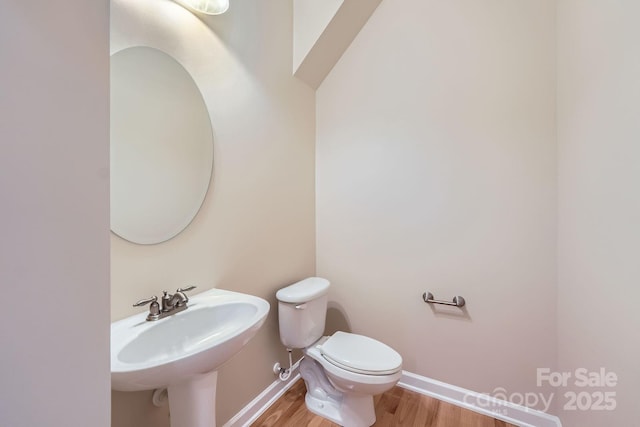 1151 Donelea Ln NW, Concord, NC 28027 - bathroom with baseboards, wood finished floors, a sink, and toilet