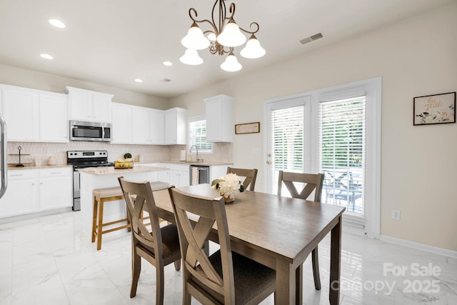 dining area with marble finish floor, a chandelier, visible vents, and recessed lighting