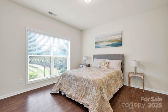 bedroom featuring baseboards, multiple windows, and visible vents