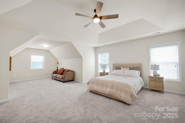 carpeted bedroom with visible vents, vaulted ceiling, baseboards, and ceiling fan