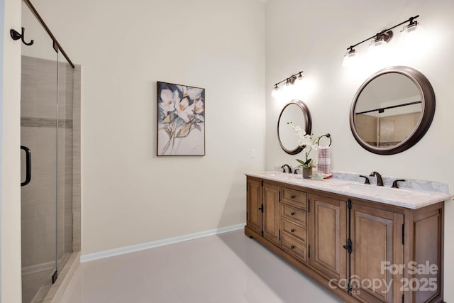 bathroom with tile patterned flooring, a sink, double vanity, and a stall shower