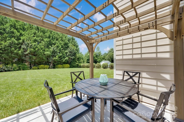 deck featuring a pergola, outdoor dining area, a yard, and a patio