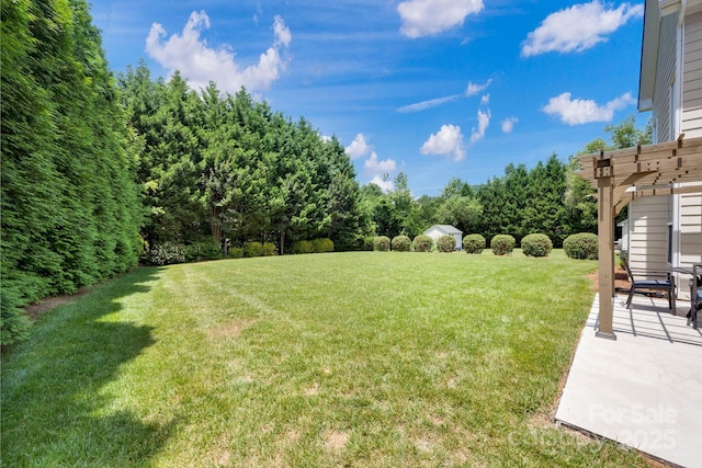 view of yard with a pergola and a patio area