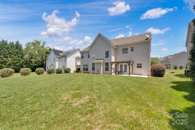 back of property with a lawn, a pergola, and a patio area