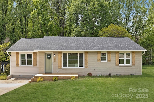 single story home featuring brick siding, crawl space, roof with shingles, and a front yard