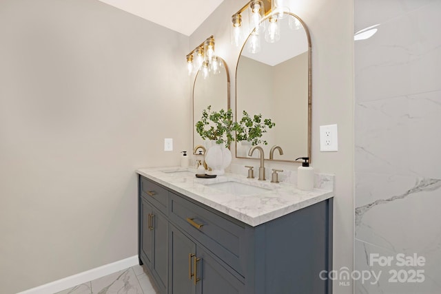 full bathroom with baseboards, marble finish floor, a sink, and double vanity