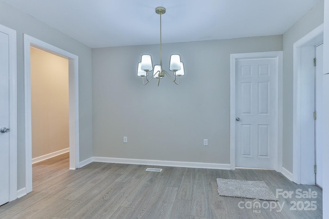 3424 Walker Cir, Lenoir, NC 28645 - unfurnished dining area featuring baseboards, light wood finished floors, a chandelier, and visible vents