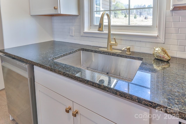 3424 Walker Cir, Lenoir, NC 28645 - room details with stainless steel dishwasher, a sink, white cabinetry, backsplash, and dark stone counters