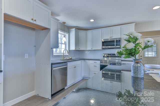 3424 Walker Cir, Lenoir, NC 28645 - kitchen featuring plenty of natural light, a sink, dark stone countertops, backsplash, and stainless steel appliances