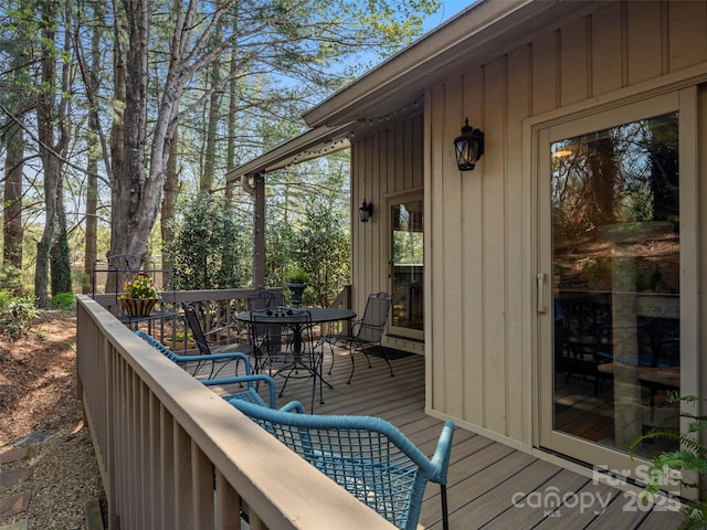 wooden terrace featuring outdoor dining space
