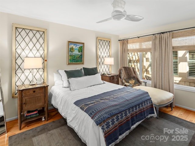 bedroom with baseboards, wood finished floors, and ceiling fan