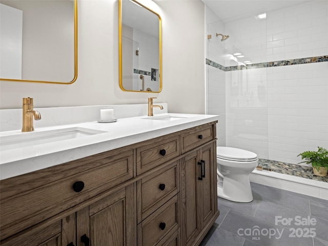 full bath with toilet, tiled shower, and a sink