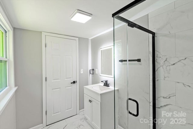 full bathroom featuring marble finish floor, baseboards, vanity, and a marble finish shower