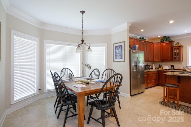 dining space featuring plenty of natural light, crown molding, baseboards, and light tile patterned floors