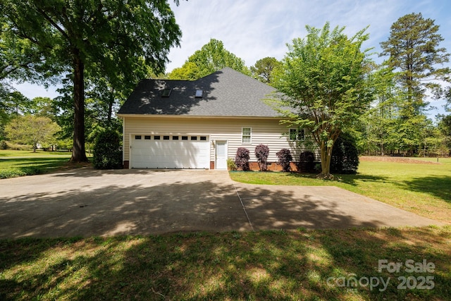 view of home's exterior featuring roof with shingles, a yard, driveway, and a garage