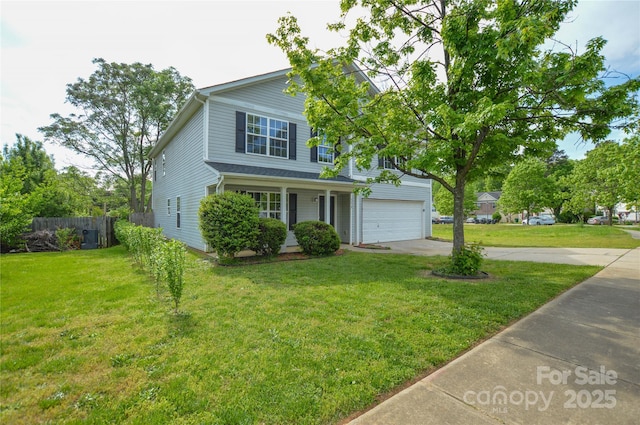 traditional-style house with a front lawn, driveway, a garage, and fence